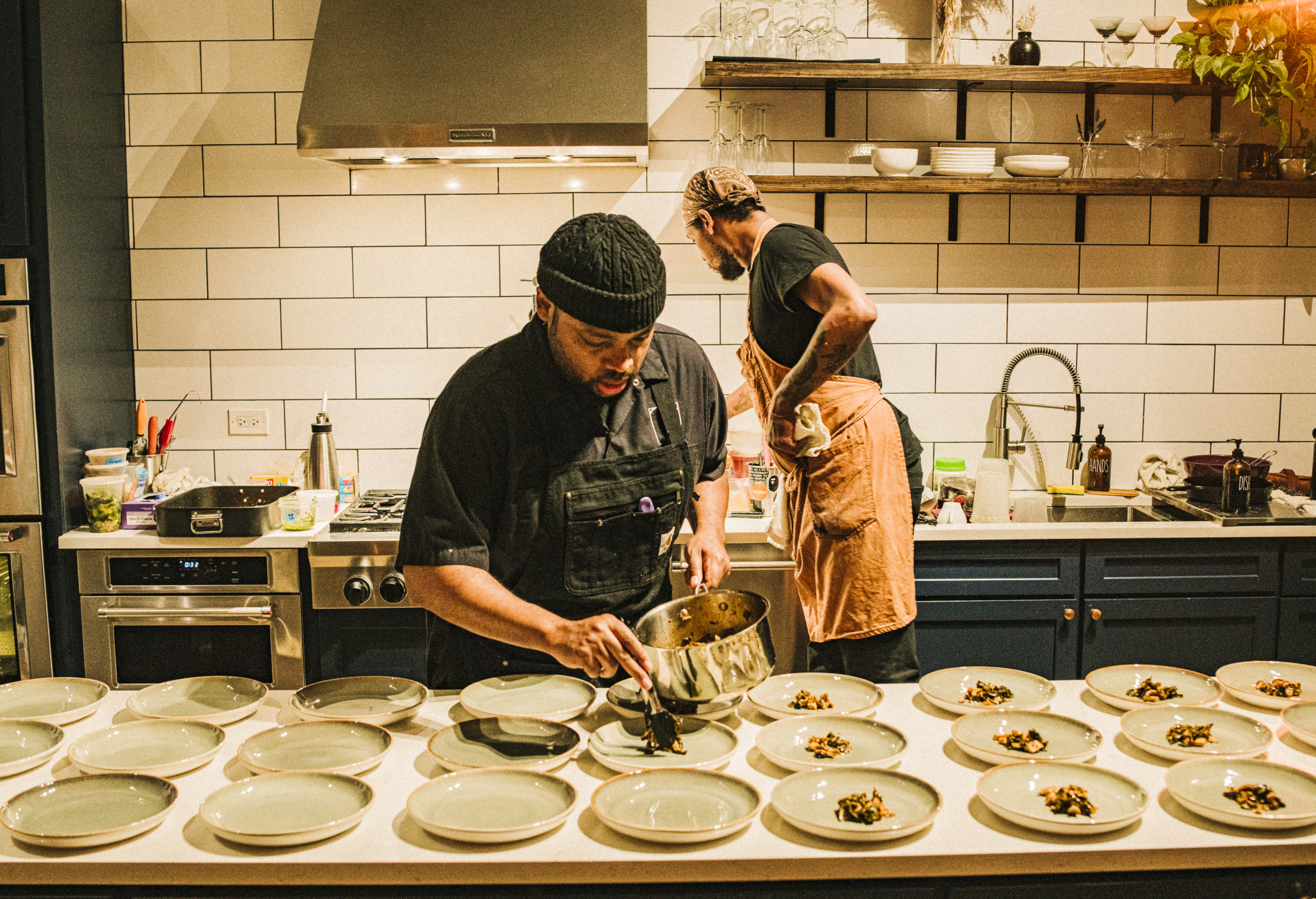 Chef Rob Carter plating, Diaspora Chicago kitchen